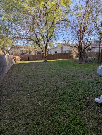 a view of a backyard with large trees