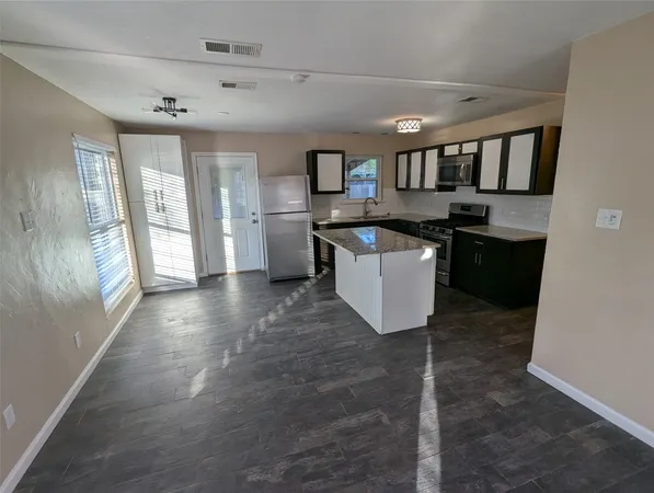 a kitchen with stainless steel appliances granite countertop a sink and stove