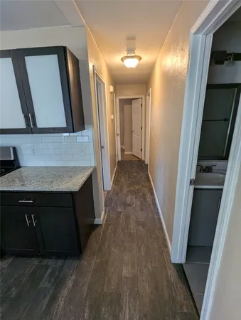 a view of hallway with wooden floor