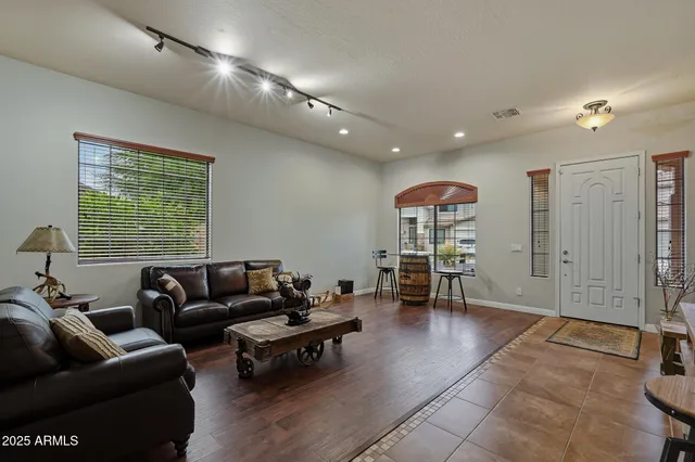 a living room with furniture a rug and a floor to ceiling window
