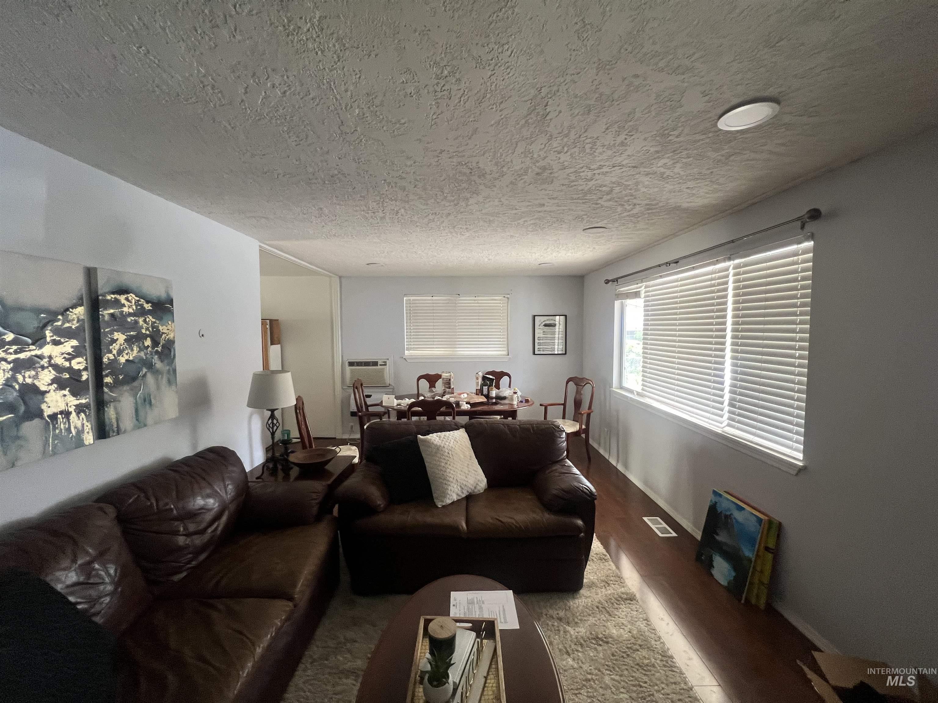 908 13th Street Kamiah, ID 83536 - Photo 3 of 12 Living room with wood finished floors and a textured ceiling