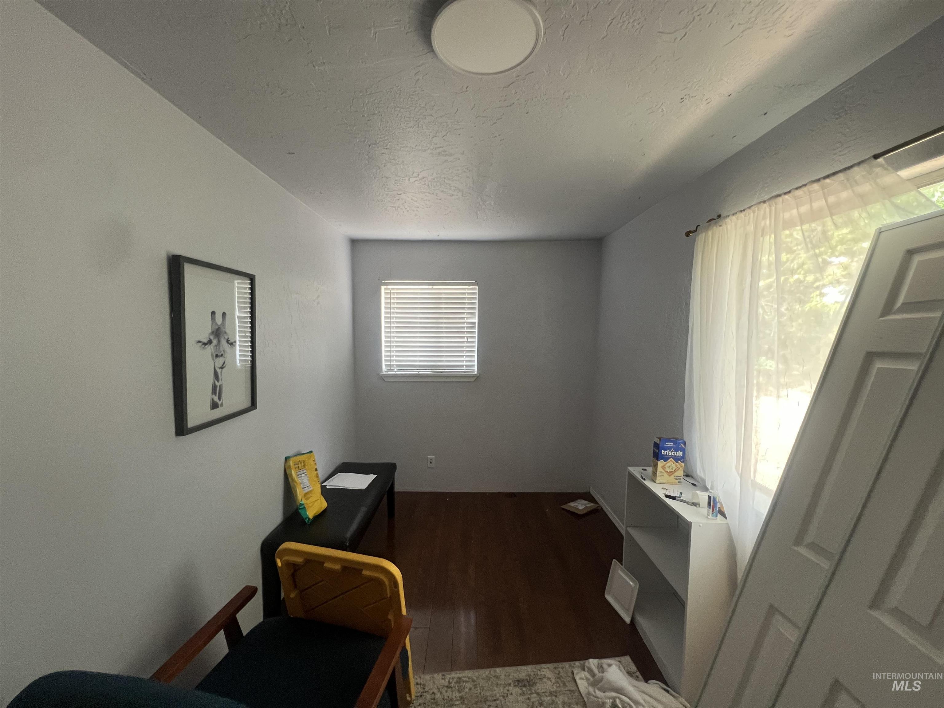 908 13th Street Kamiah, ID 83536 - Photo 6 of 12 Office area with a textured ceiling and wood finished floors