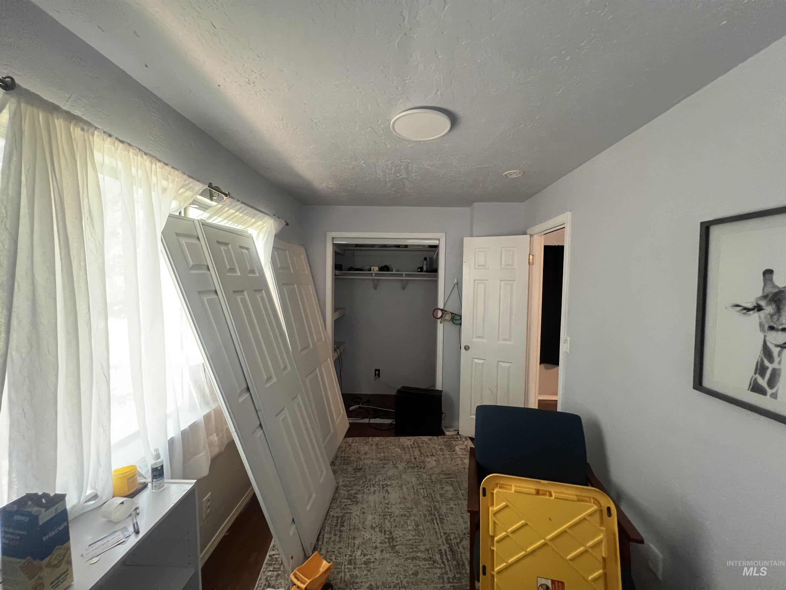 908 13th Street Kamiah, ID 83536 - Photo 7 of 12 Bedroom featuring a textured ceiling and a closet
