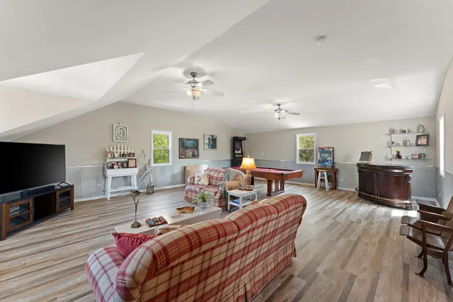 a living room with fireplace furniture and a flat screen tv