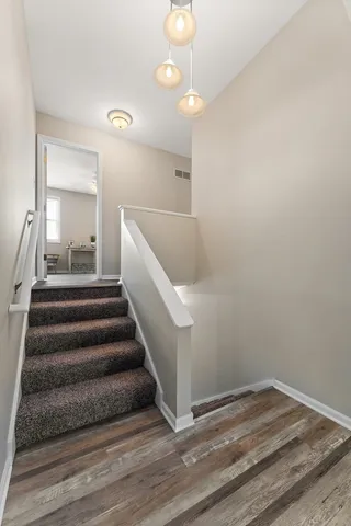 a view of entryway and hall with wooden floor