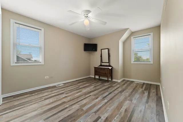 a room with a window and a wooden floor