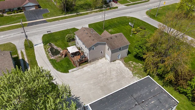 an aerial view of a house with garden space and street view