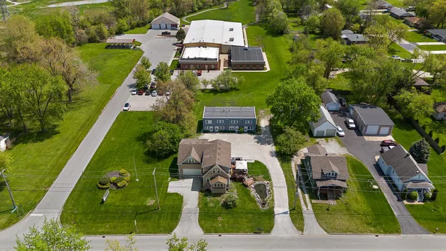 an aerial view of a house with a garden and a swimming pool