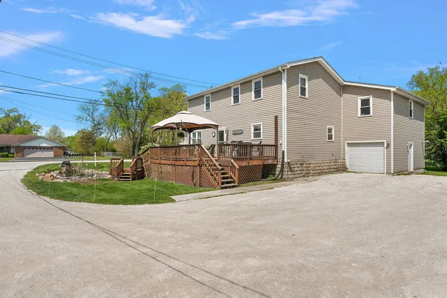 a view of a patio with table and chairs and wooden floor