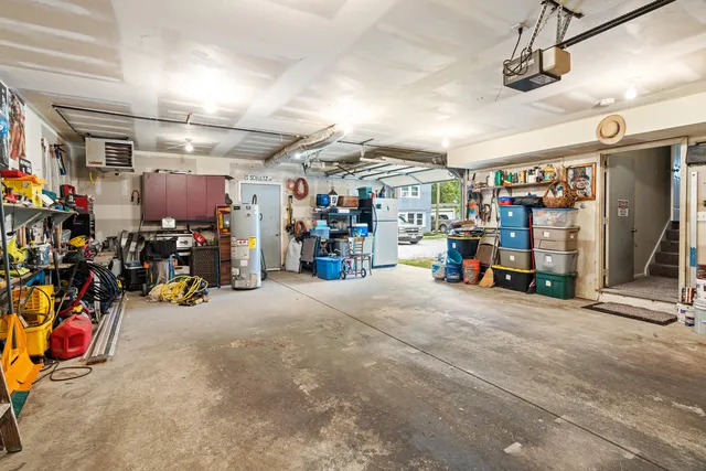 a front view of a house with garden and trees