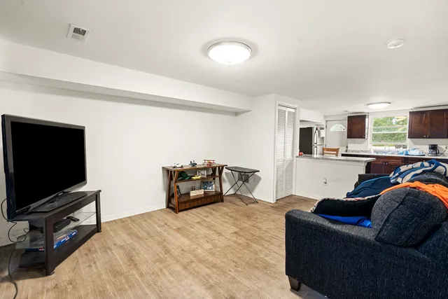 a kitchen with a sink a microwave and wooden cabinets