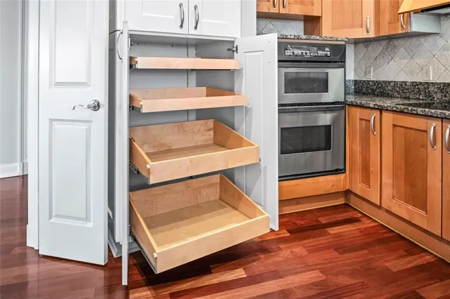 a kitchen with a refrigerator and a stove top oven