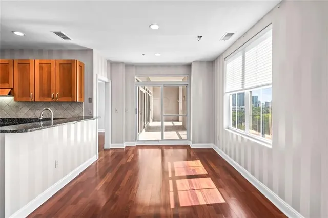 a view of a kitchen with a sink and wooden floor