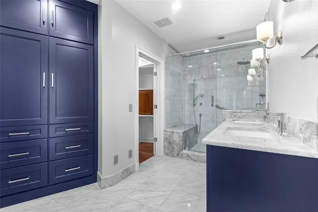 a bathroom with a sink shower and a mirror