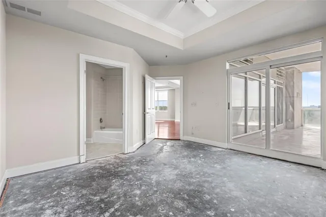 a view of an empty room with glass door and a window