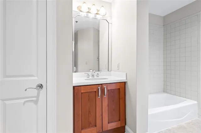 a bathroom with a bath tub and a sink