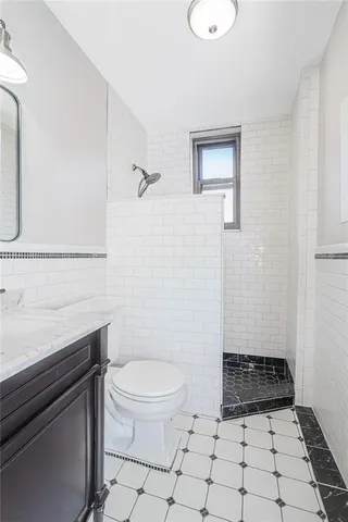 a bathroom with a toilet a sink and a mirror