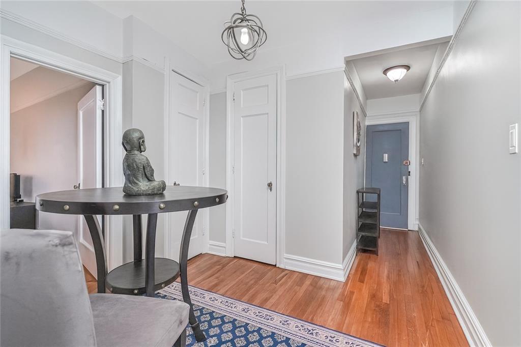 255 79th Street, Unit E2 Brooklyn, NY 11209 - Photo 4 of 14 a view of a hallway with wooden floor and staircase