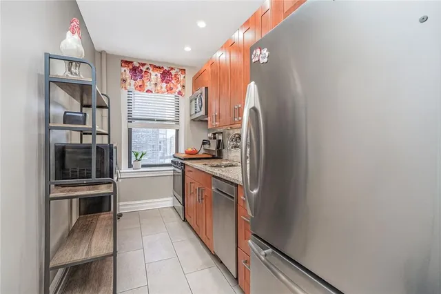 a kitchen with stainless steel appliances granite countertop a refrigerator and a sink
