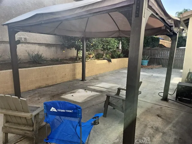 a view of a balcony with wooden floor and potted plants