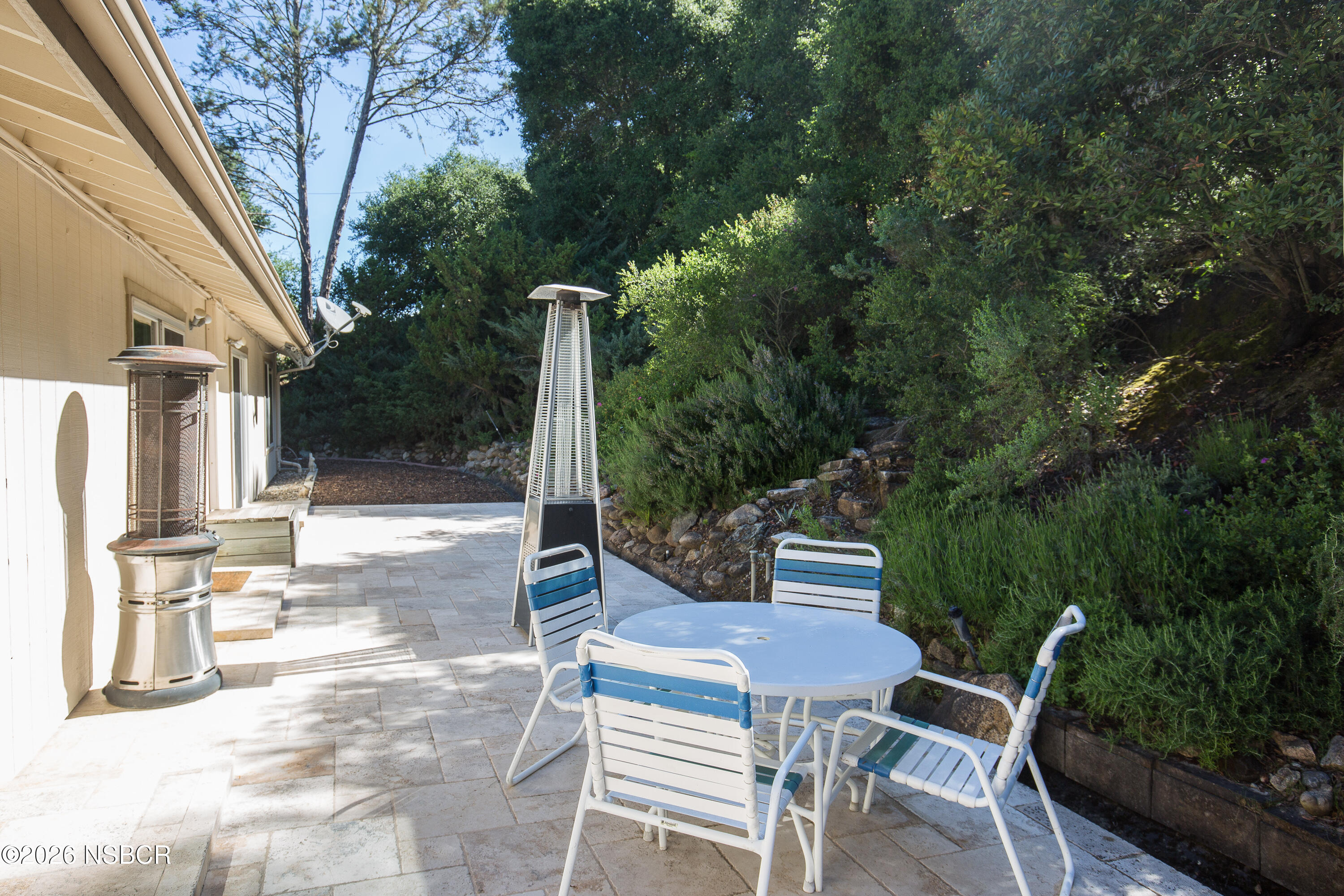 850 Fredensborg Canyon Road Solvang, CA 93463 - Photo 21 of 26 a view of a patio with table and chairs and floor to ceiling window