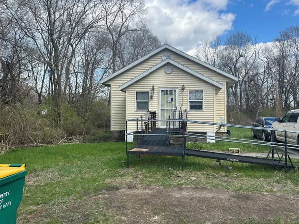 a front view of a house with a yard table and chairs