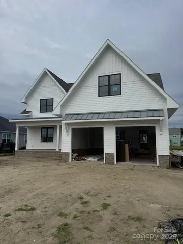 a front view of a house with yard and garage