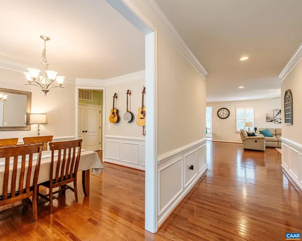 a large white kitchen with lots of counter space dining table and chairs