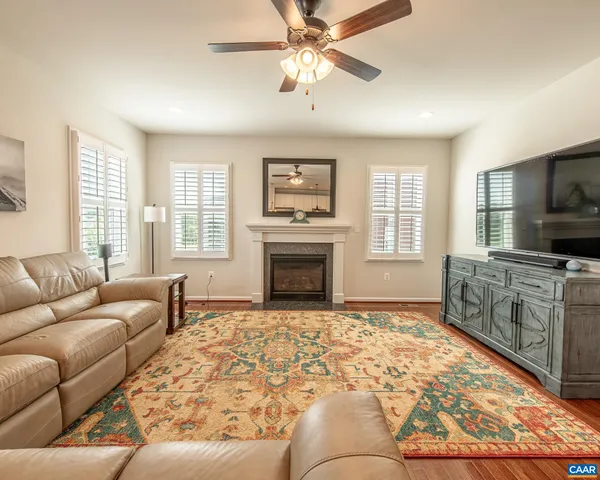 a bedroom with a large bed and ceiling fan