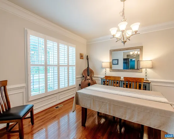 a large kitchen with cabinets wooden floor and stainless steel appliances