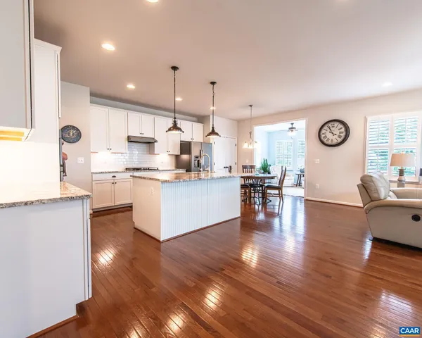 a view of house with garden space and a car parked in front of it