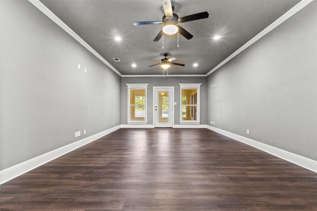 910 County Road 1111 Decatur, TX 76234 - Photo 20 of 40 Unfurnished room featuring dark wood-style floors, ornamental molding, recessed lighting, and ceiling fan