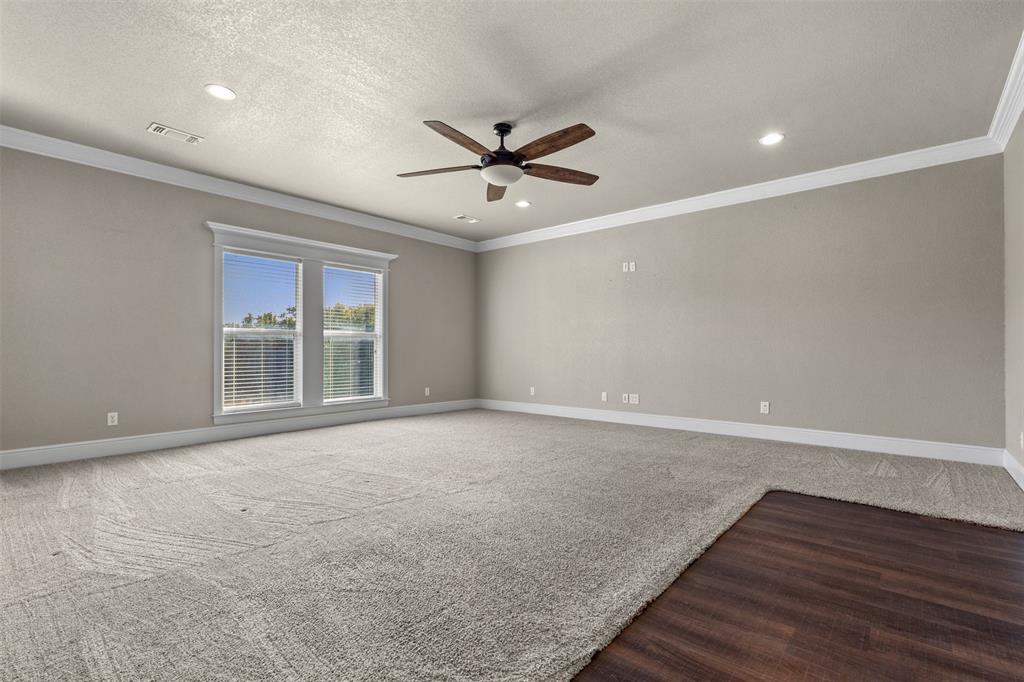 910 County Road 1111 Decatur, TX 76234 - Photo 21 of 40 Carpeted spare room featuring crown molding, recessed lighting, a textured ceiling, ceiling fan, and wood finished floors