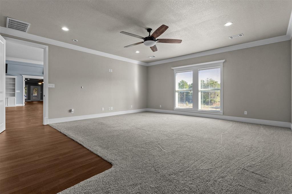 910 County Road 1111 Decatur, TX 76234 - Photo 22 of 40 Unfurnished room featuring a ceiling fan, ornamental molding, a textured ceiling, recessed lighting, and wood finished floors