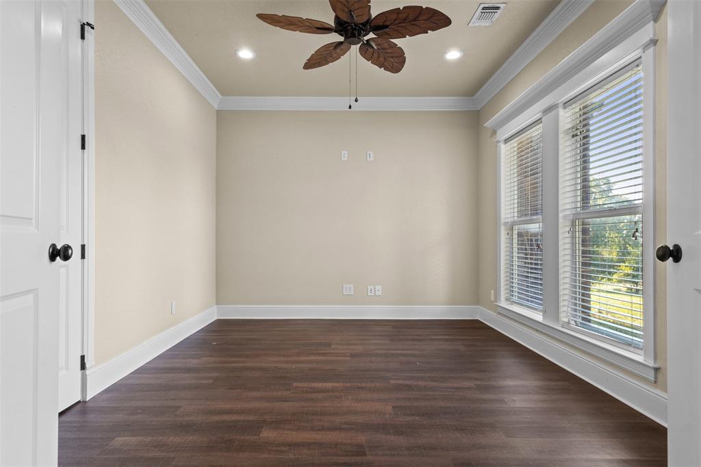 910 County Road 1111 Decatur, TX 76234 - Photo 23 of 40 Empty room with ornamental molding, dark wood-type flooring, recessed lighting, and a ceiling fan