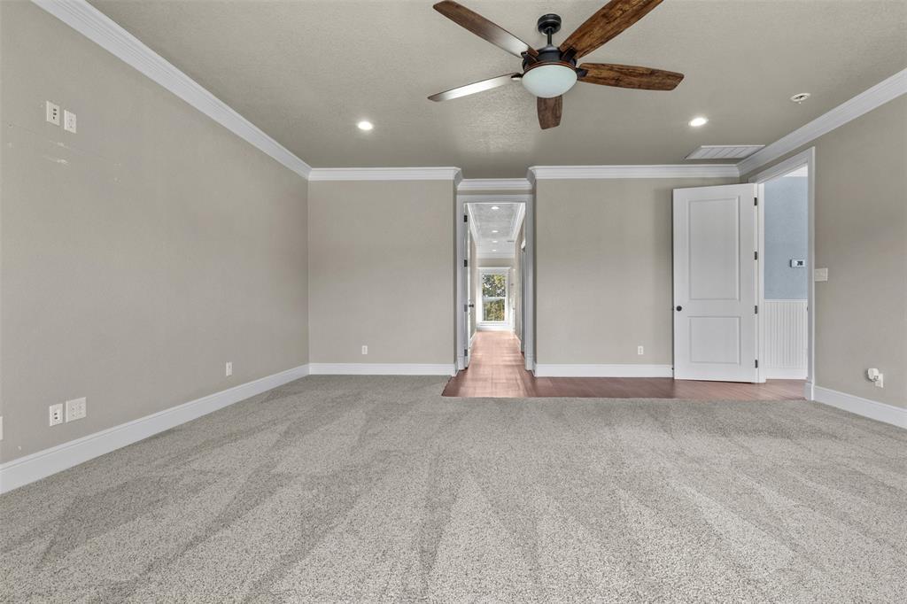 910 County Road 1111 Decatur, TX 76234 - Photo 24 of 40 Unfurnished bedroom featuring light carpet, recessed lighting, ornamental molding, and a ceiling fan