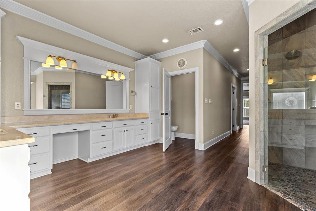 910 County Road 1111 Decatur, TX 76234 - Photo 30 of 40 Bathroom featuring vanity, ornamental molding, a shower stall, recessed lighting, and dark wood-style flooring
