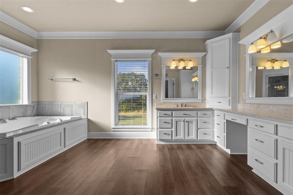 910 County Road 1111 Decatur, TX 76234 - Photo 31 of 40 Full bathroom with vanity, a garden tub, dark wood-style floors, crown molding, and recessed lighting