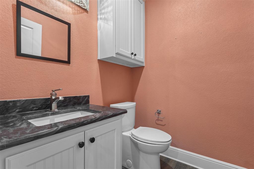 910 County Road 1111 Decatur, TX 76234 - Photo 38 of 40 Bathroom with a textured wall and vanity