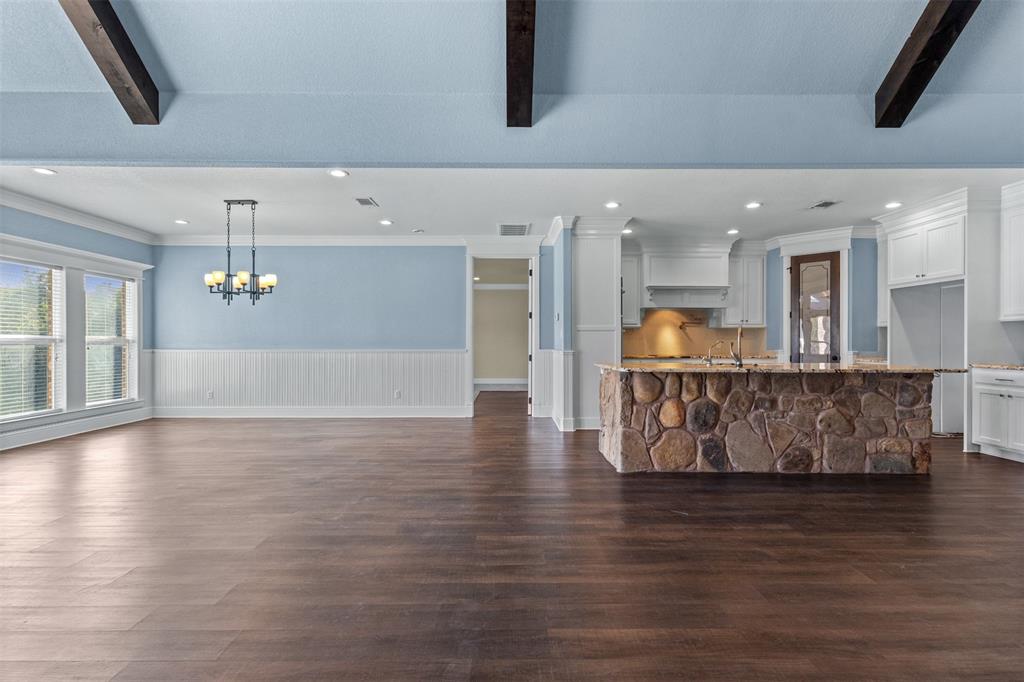910 County Road 1111 Decatur, TX 76234 - Photo 8 of 40 Unfurnished living room featuring dark wood finished floors, recessed lighting, a wainscoted wall, and a chandelier