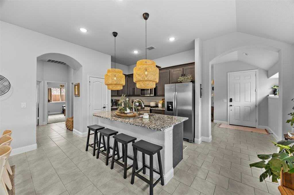 1084 Imperial Eagle Road Alvarado, TX 76009 - Photo 10 of 39 a kitchen with granite countertop a table and chairs