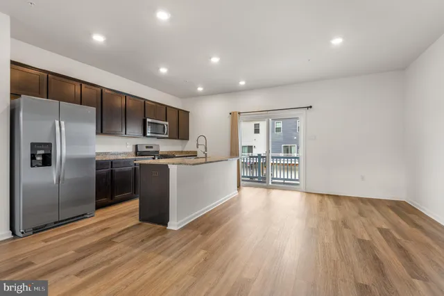 a kitchen with stainless steel appliances a refrigerator and a microwave