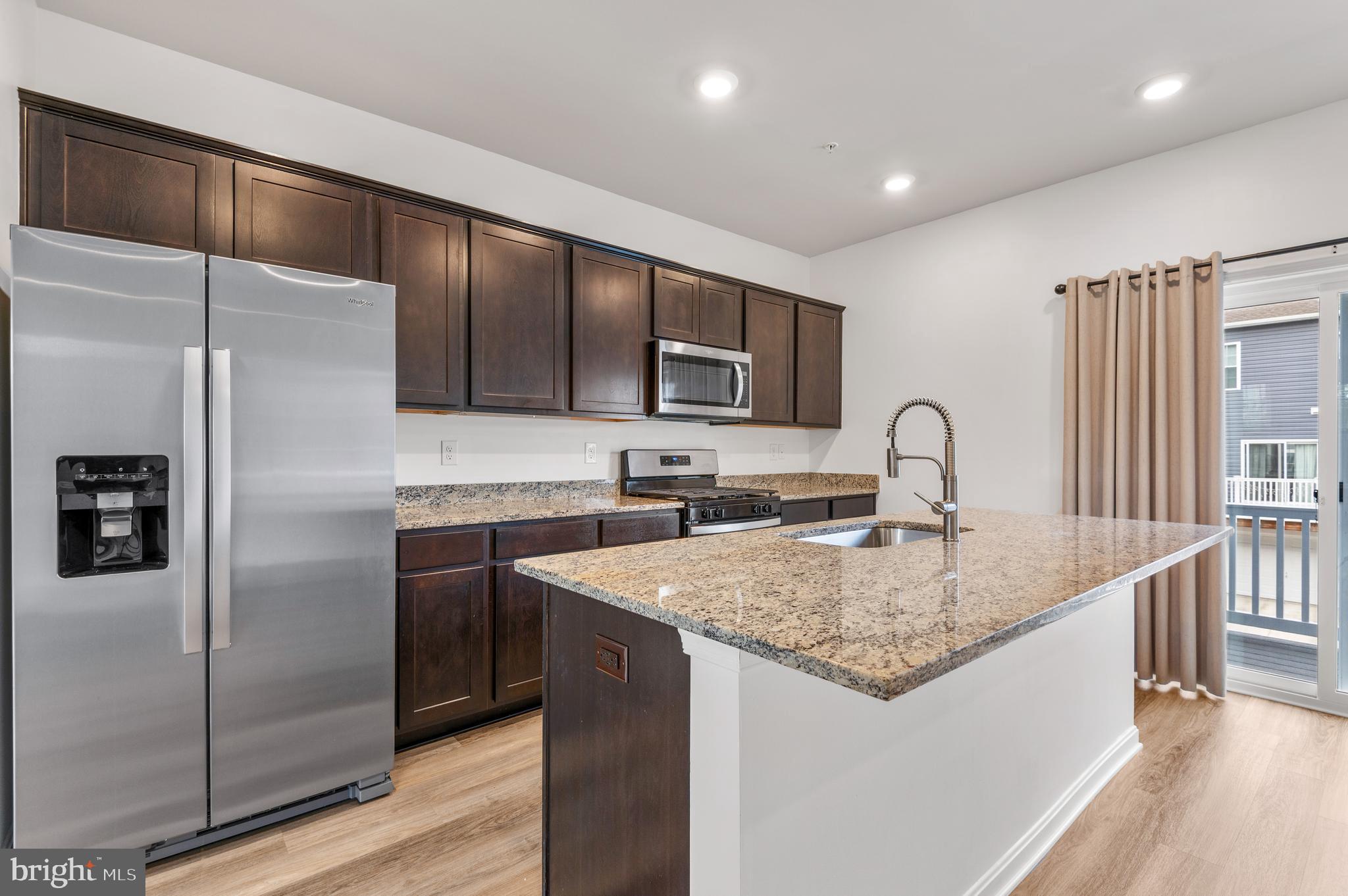 8612 Walter Martz Road Frederick, MD 21702 - Photo 19 of 51 a kitchen with stainless steel appliances granite countertop a sink stove and refrigerator
