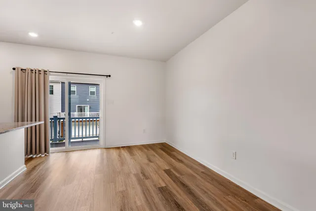a view of a room with wooden floor and a gate