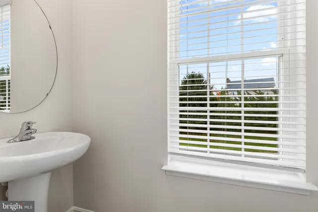 a bathroom with a sink and a window