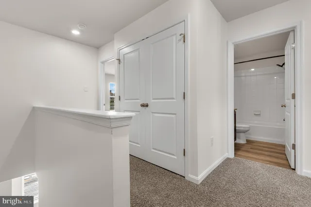 an empty room with windows and mirror