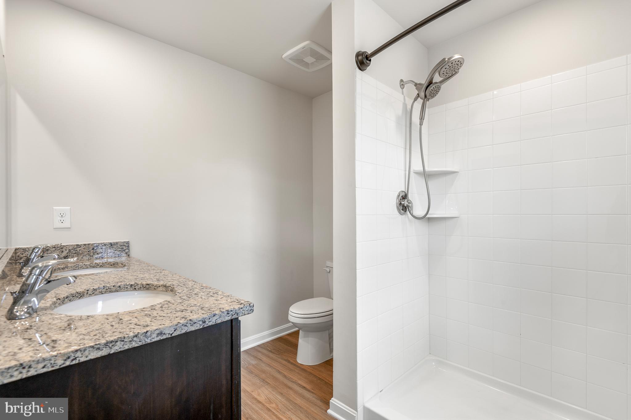 8612 Walter Martz Road Frederick, MD 21702 - Photo 34 of 51 a bathroom with a granite countertop sink a toilet and shower