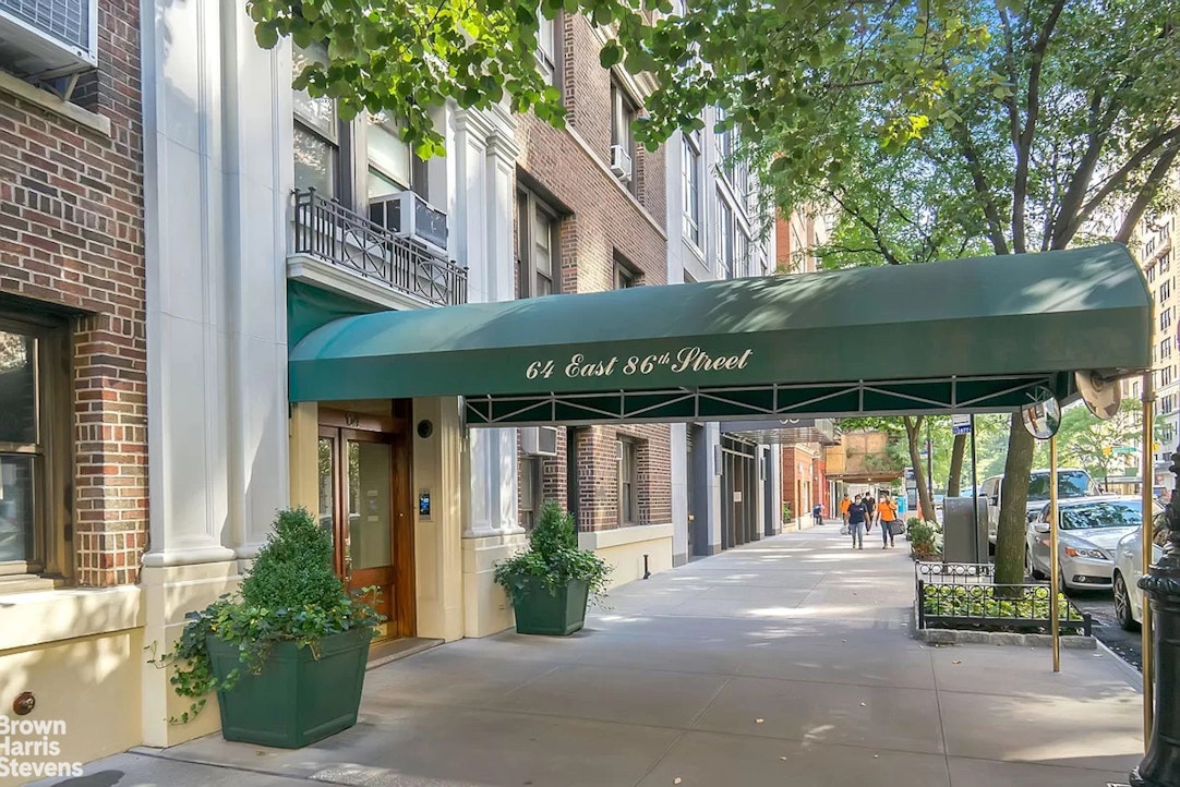 64 East 86th Street, Unit 12AB Manhattan, NY 10028 - Photo 10 of 15 a view of a cafe with a table and chairs under an umbrella