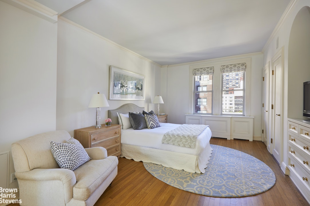 64 East 86th Street, Unit 12AB Manhattan, NY 10028 - Photo 5 of 15 a living room with furniture and a large window