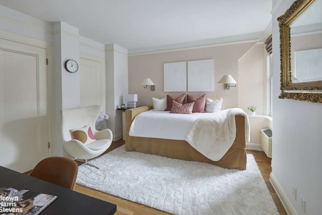 64 East 86th Street, Unit 12AB Manhattan, NY 10028 - Photo 6 of 15 a bedroom with a bed and wooden floor